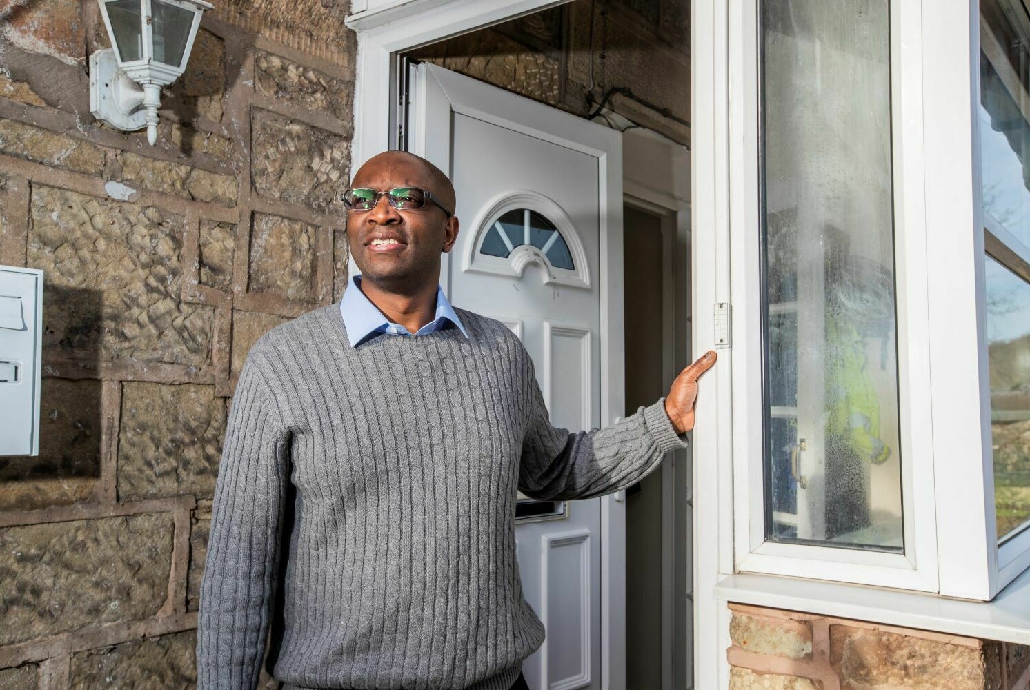 Martin Katawalliwa standing by front door