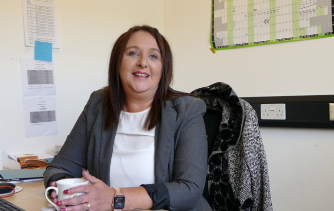 Emmaline smiling at her desk