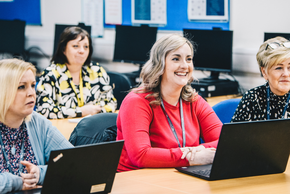 Apprentice's learning at a desk with laptops