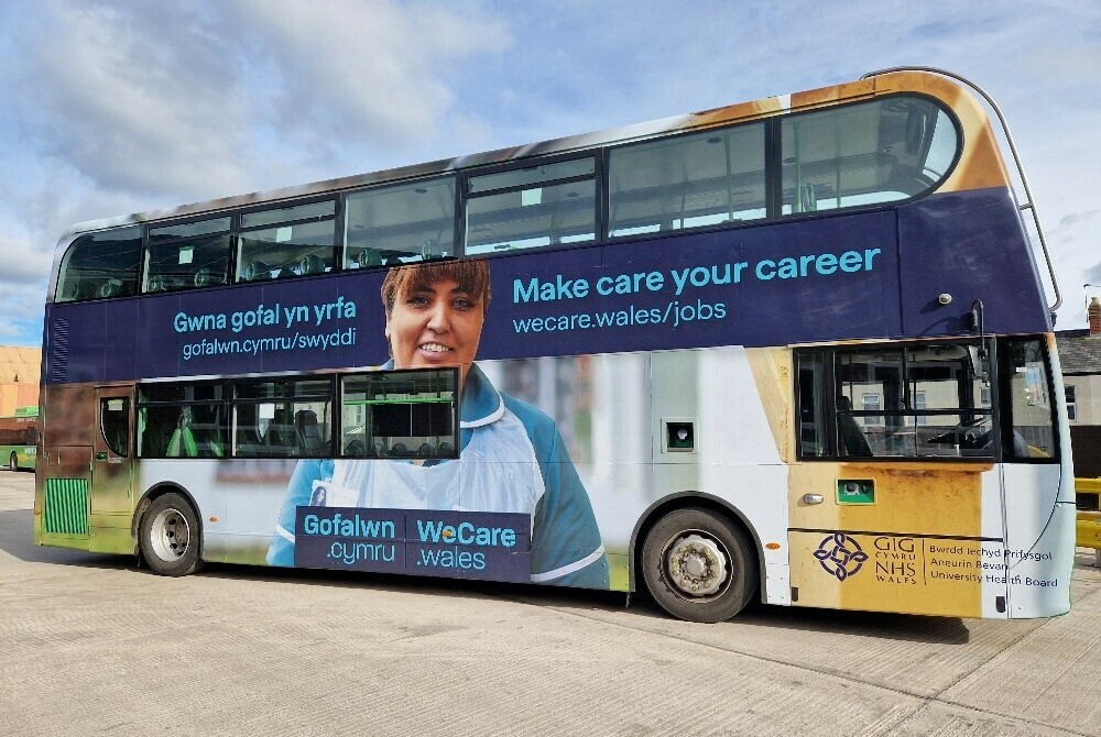 Bus printed with We Care Wales signage saying "Make care your career"